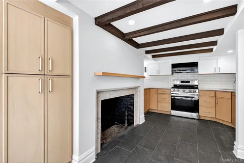 a kitchen with white cabinets and appliances
