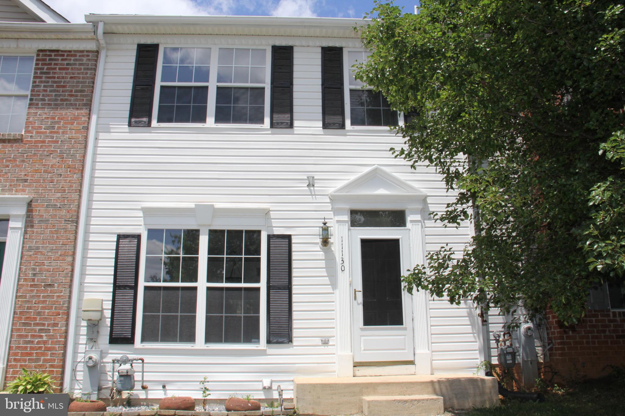 Charming townhouse with classic curb appeal.