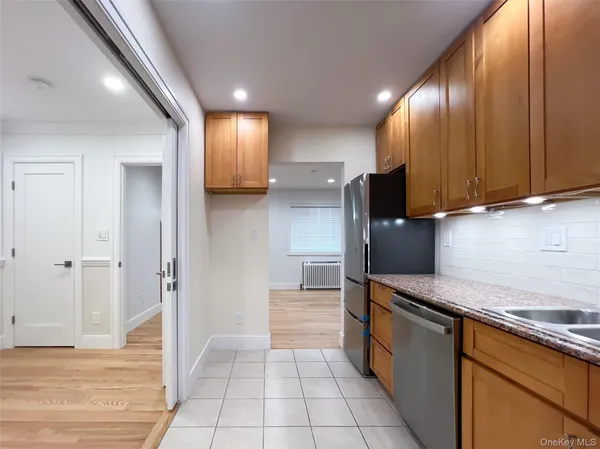 a kitchen with stainless steel appliances granite countertop a refrigerator and a stove