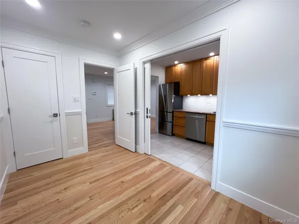 a view of empty room with wooden floor and cabinet