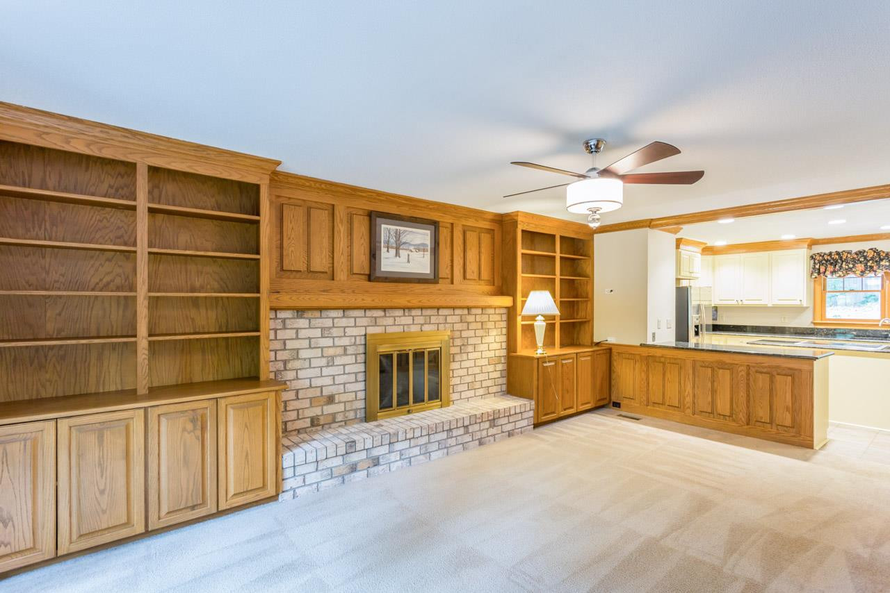 5200 Country Trail Raleigh, NC 27613 - Photo 4 of 25 Gorgeous oak millwork details on the trim in this home. You don't find beautiful trim like this in newer construction! Built-ins flank a gas log fireplace with attached screen. Brick hearth. Den/Family/Great Room