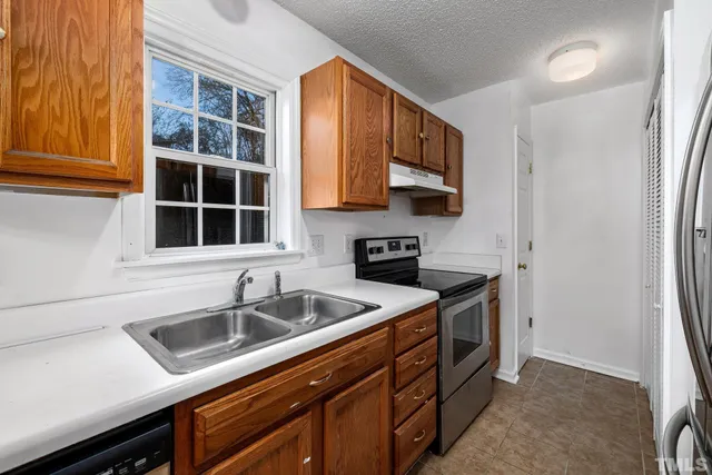 a kitchen that has a sink and a stove