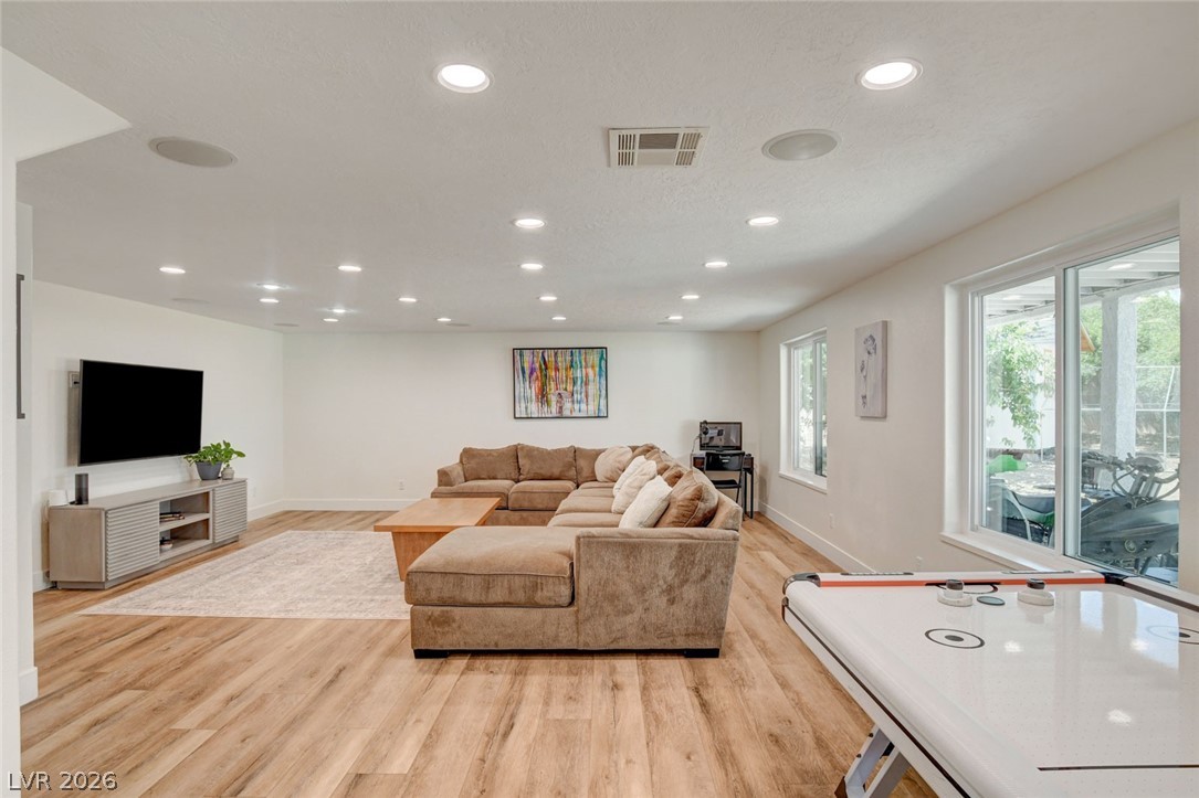 4362 Thistle Street Logandale, NV 89021 - Photo 45 of 99 Recessed lighting illuminates this bright, well-appointed living area with durable LVP flooring and ample space for entertainment.