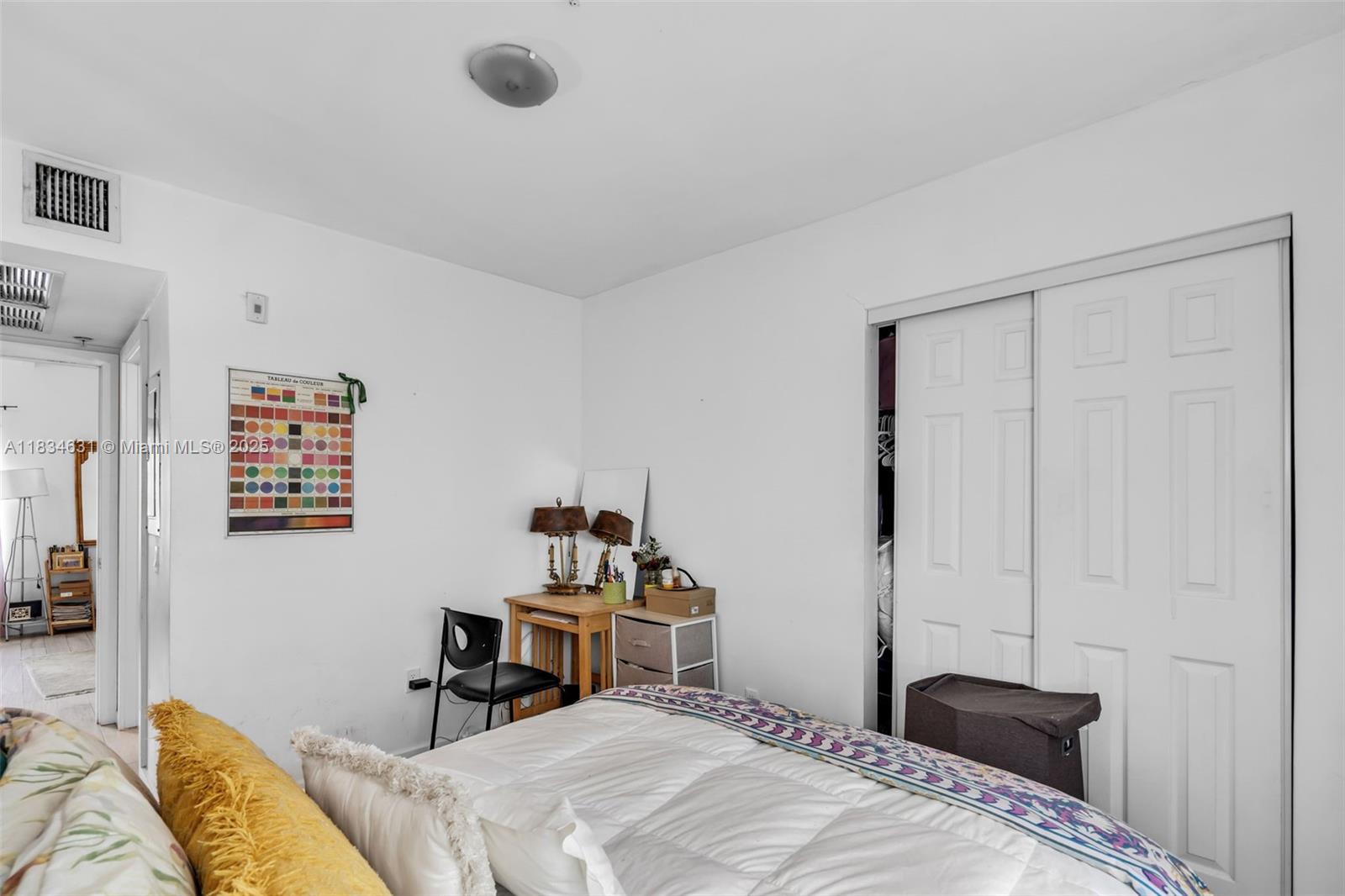 1450 Meridian Avenue, Unit 202 Miami Beach, FL 33139 - Photo 11 of 29 a bedroom with a bed and a table in it