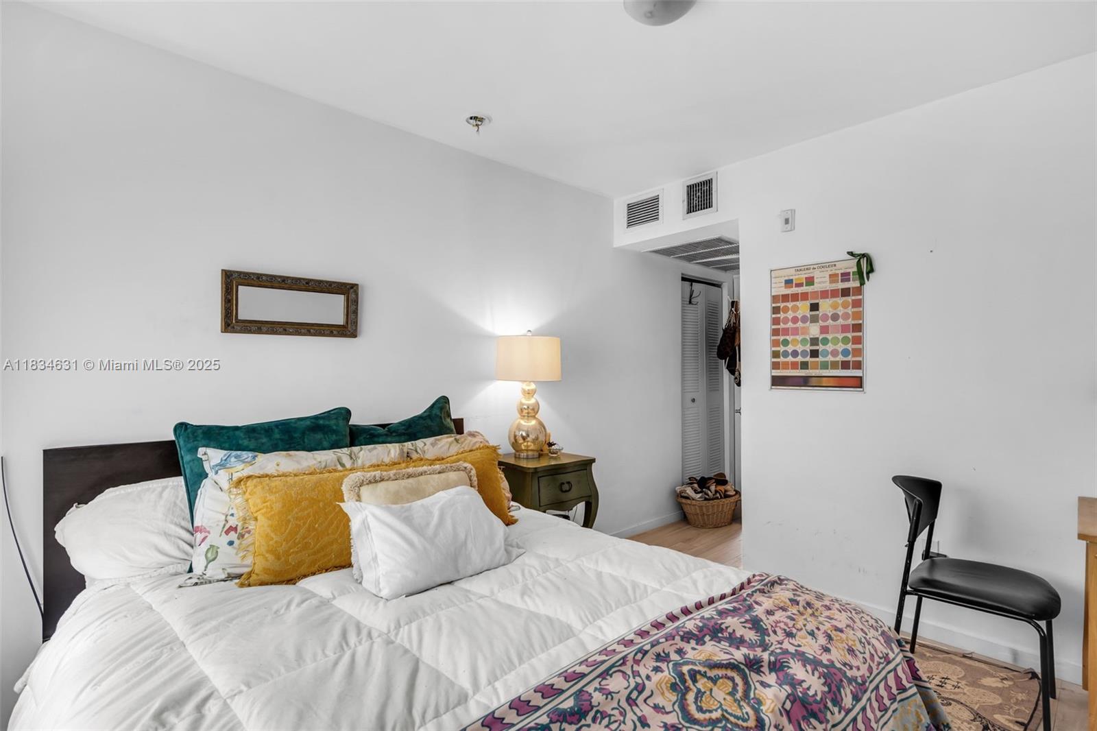 1450 Meridian Avenue, Unit 202 Miami Beach, FL 33139 - Photo 12 of 29 a bedroom with a bed and wooden floor