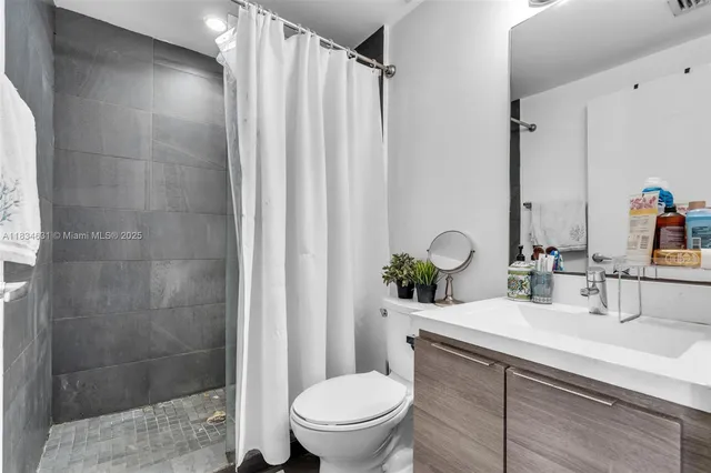 a bathroom with a sink toilet and shower
