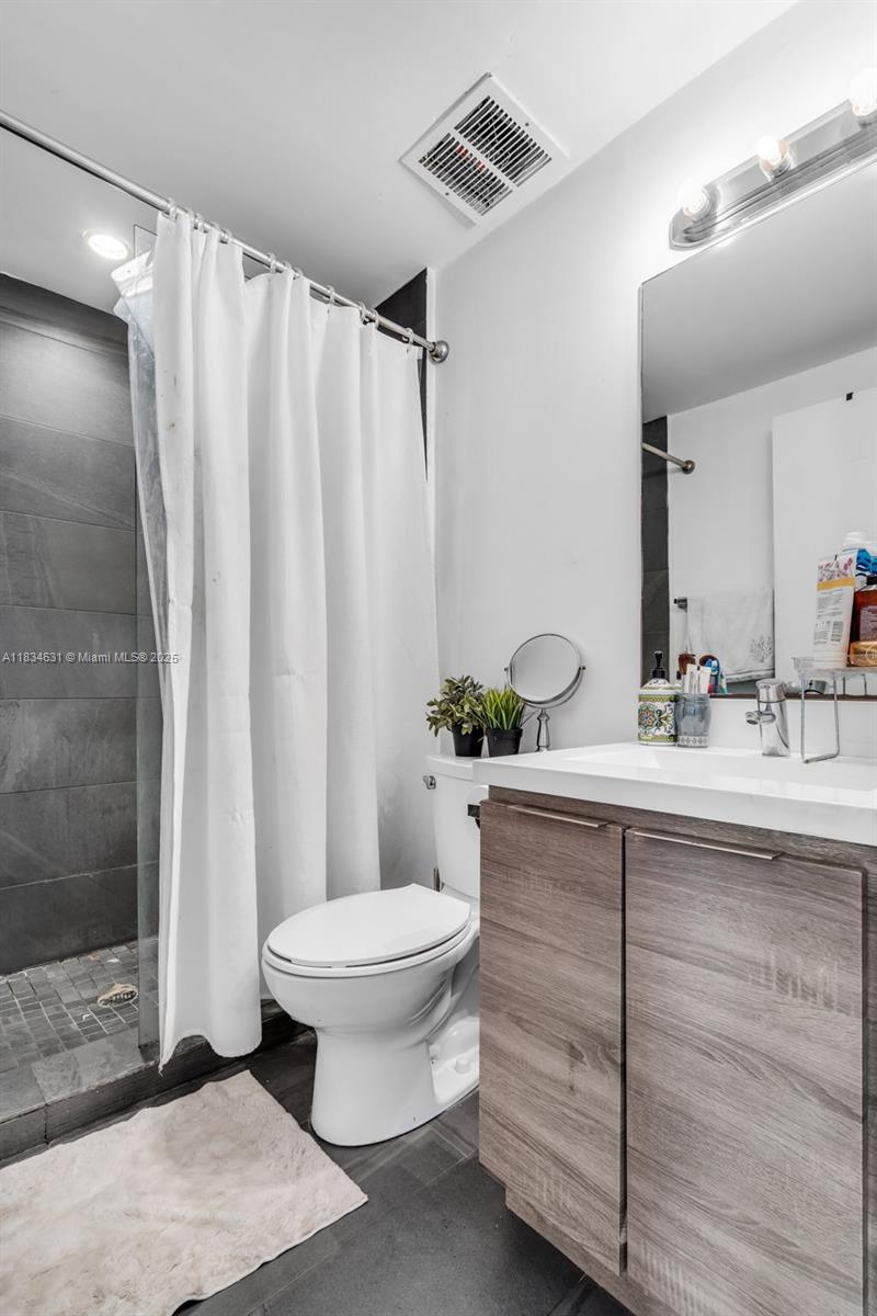 1450 Meridian Avenue, Unit 202 Miami Beach, FL 33139 - Photo 14 of 29 a bathroom with a sink toilet and shower