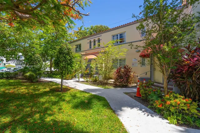a backyard of a house with a garden and plants