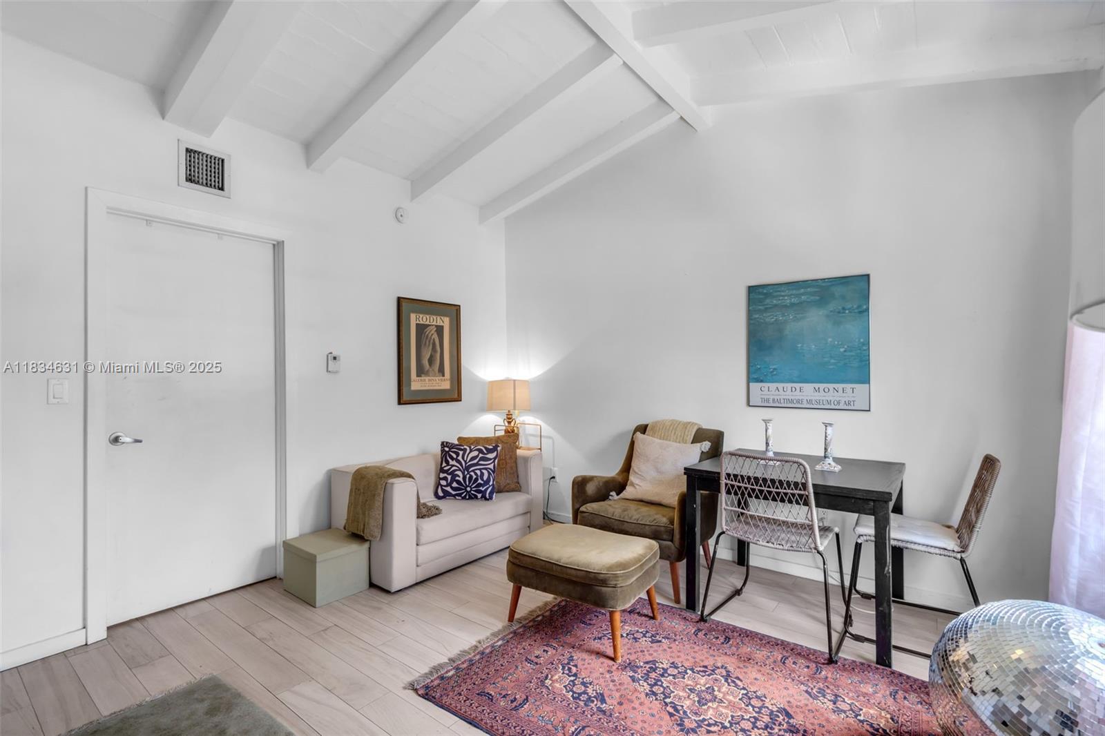 1450 Meridian Avenue, Unit 202 Miami Beach, FL 33139 - Photo 6 of 29 a living room with furniture and a wooden floor