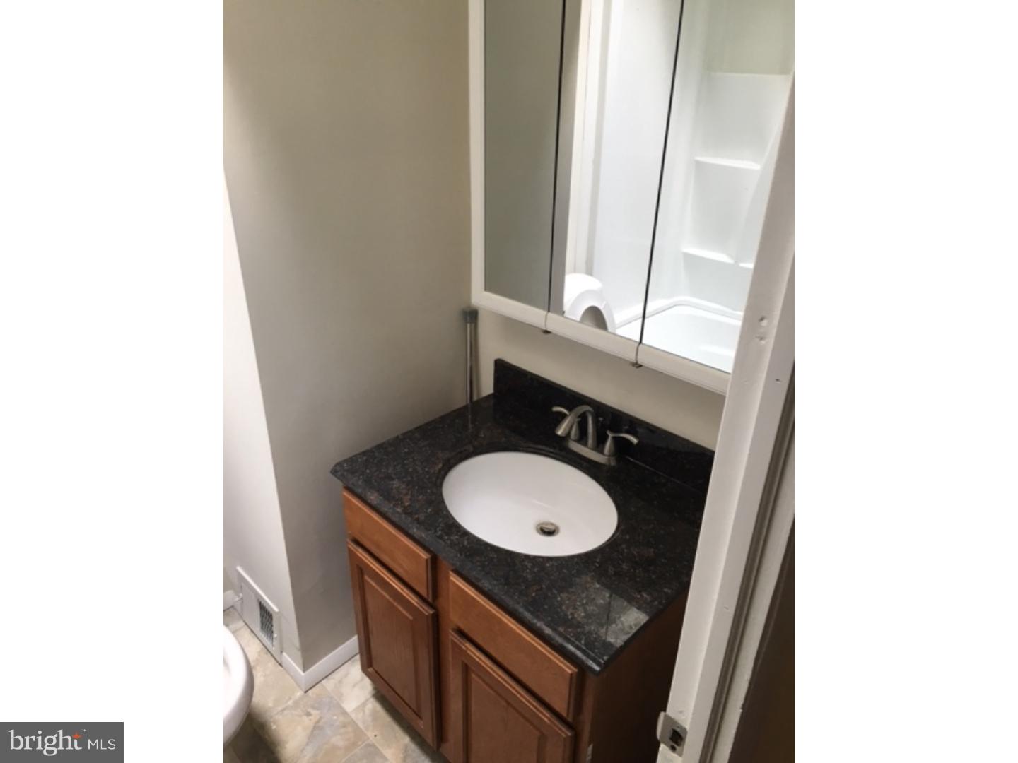 1341 Rainer Road Brookhaven, PA 19015 - Photo 11 of 23 a bathroom with a granite countertop sink and a mirror
