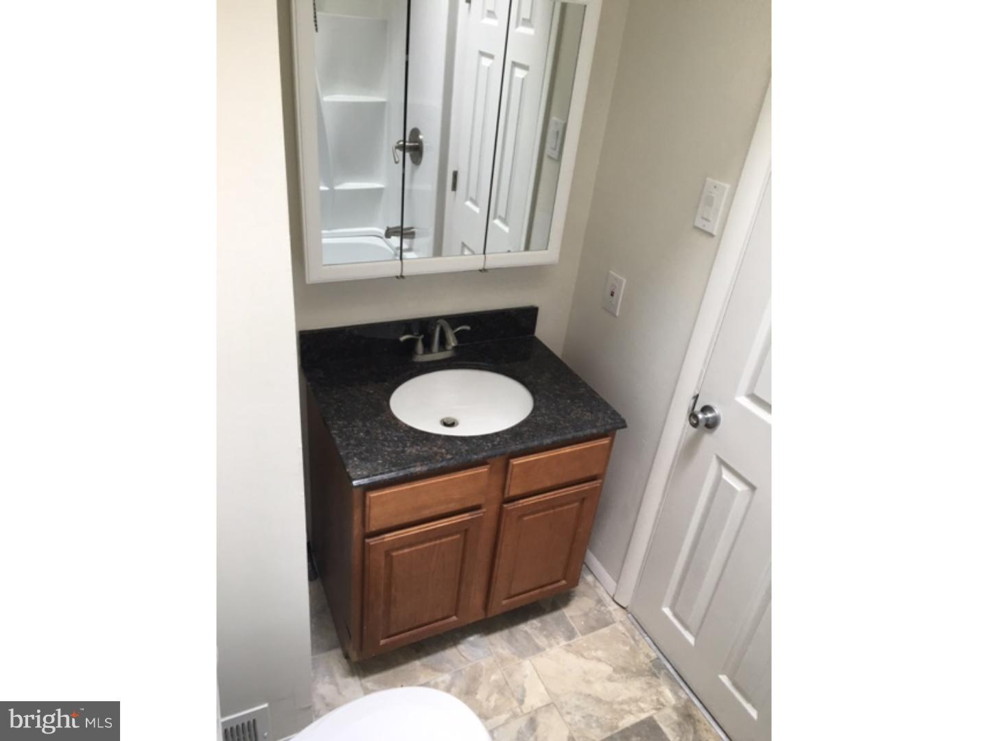 1341 Rainer Road Brookhaven, PA 19015 - Photo 14 of 23 a bathroom with a sink and a mirror