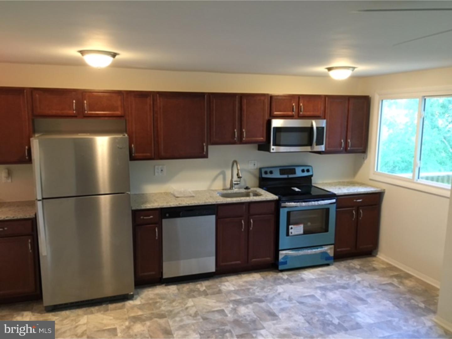 1341 Rainer Road Brookhaven, PA 19015 - Photo 22 of 23 a kitchen with stainless steel appliances granite countertop a refrigerator stove a sink dishwasher and microwave