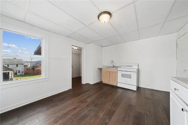 a view of a room with wooden floor and a ceiling fan