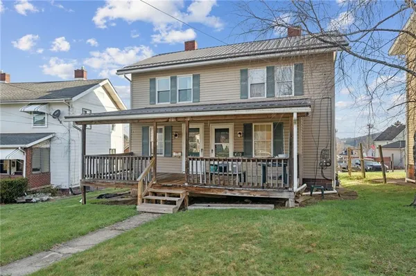 a view of a house with a yard and deck