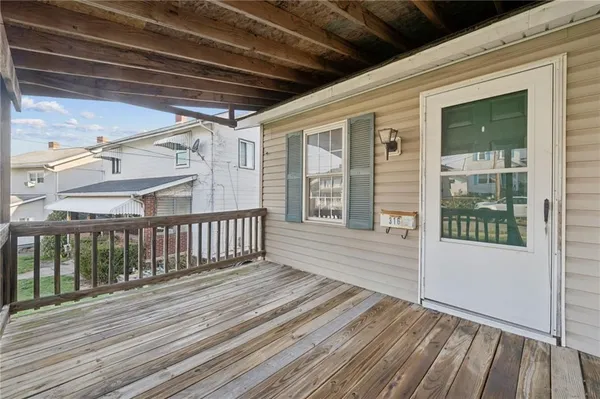 a view of a balcony with wooden floor