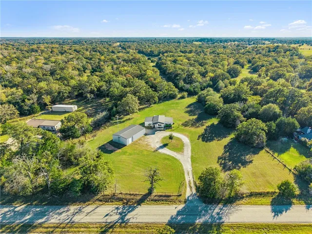 an aerial view of residential houses with outdoor space