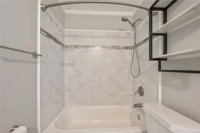 a bathroom with a bath tub with a shower