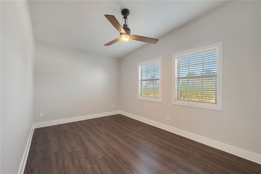 11688 Long Trussel Road Bryan, TX 77808 - Photo 14 of 29 a view of an empty room with wooden floor and a window