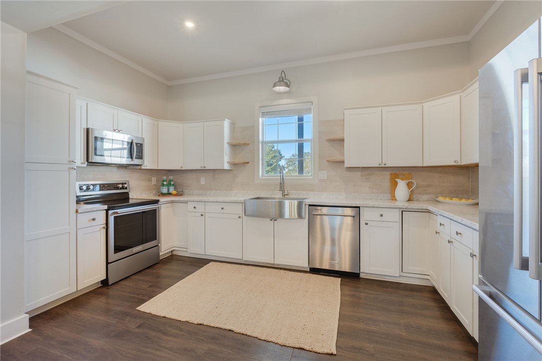 11688 Long Trussel Road Bryan, TX 77808 - Photo 7 of 29 a kitchen with granite countertop white cabinets and white appliances