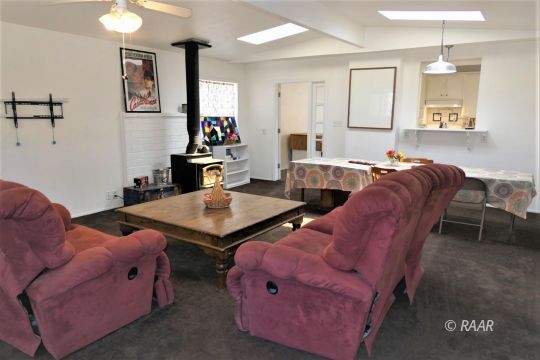 1263 Primrose Street Ridgecrest, CA 93555 - Photo 15 of 35 a living room with furniture a chandelier and a window