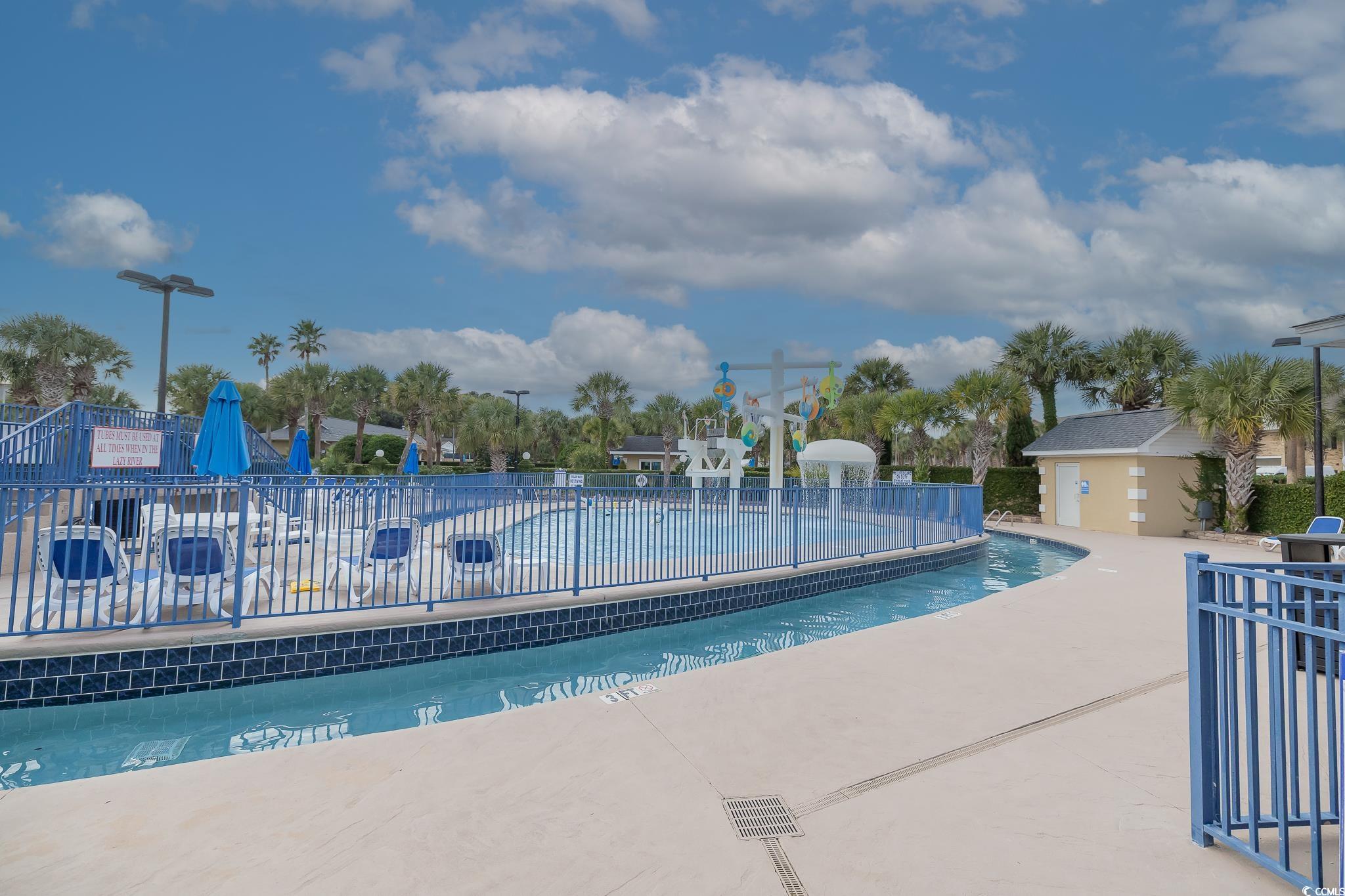 209 Double Eagle Drive, Unit F2 Surfside Beach, SC 29575 - Photo 3 of 17 Community pool featuring a patio area