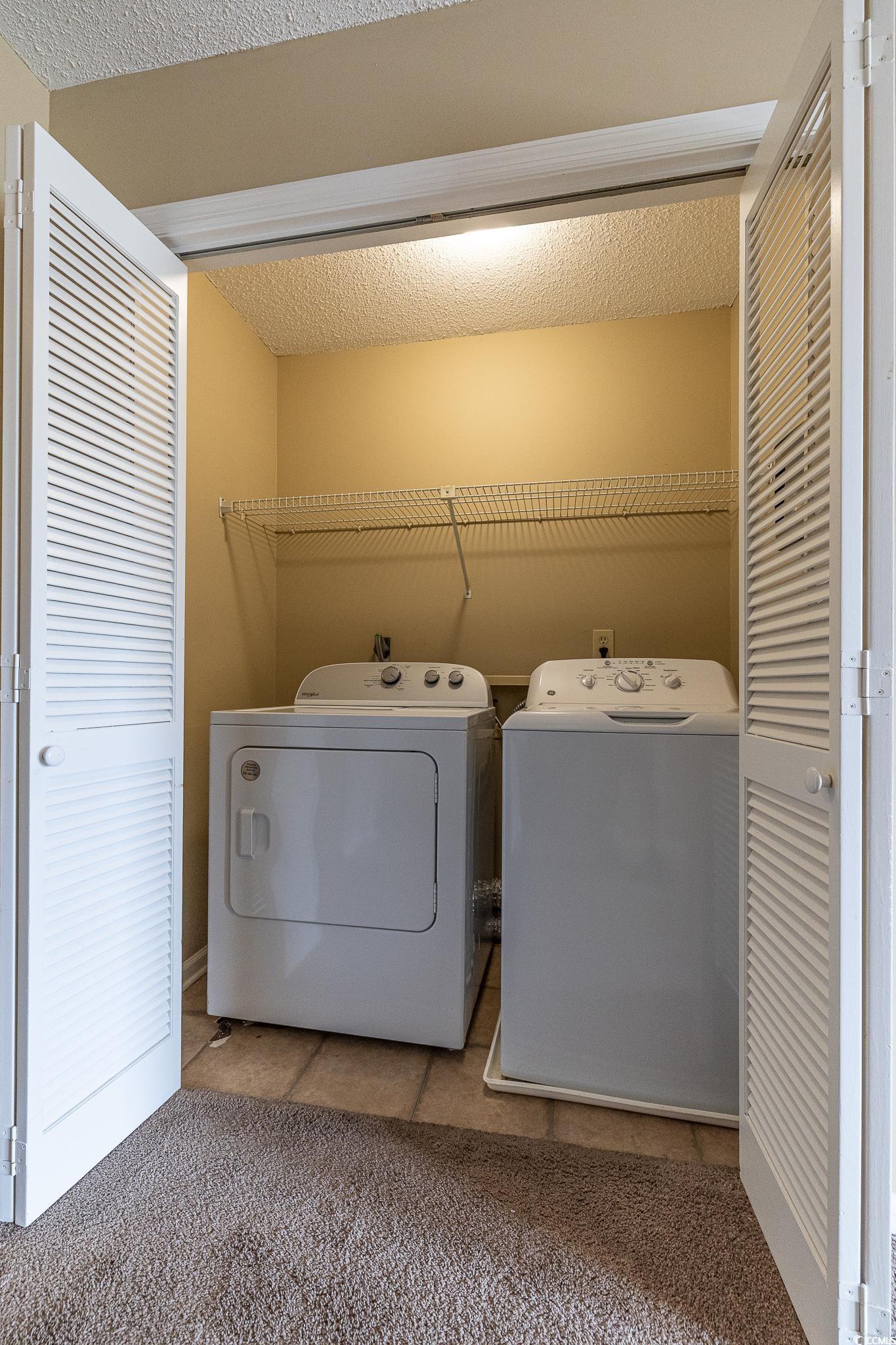 209 Double Eagle Drive, Unit F2 Surfside Beach, SC 29575 - Photo 9 of 17 Laundry area featuring independent washer and dryer, a textured ceiling, light tile patterned floors, and light carpet