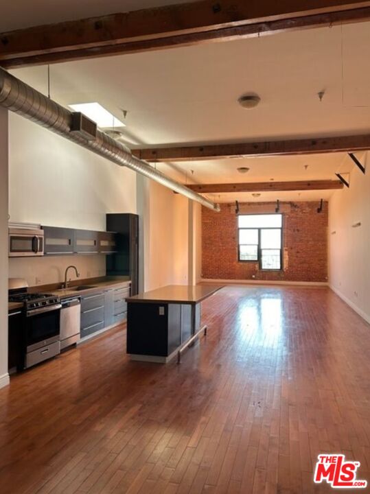 a kitchen with stainless steel appliances granite countertop a stove and a refrigerator