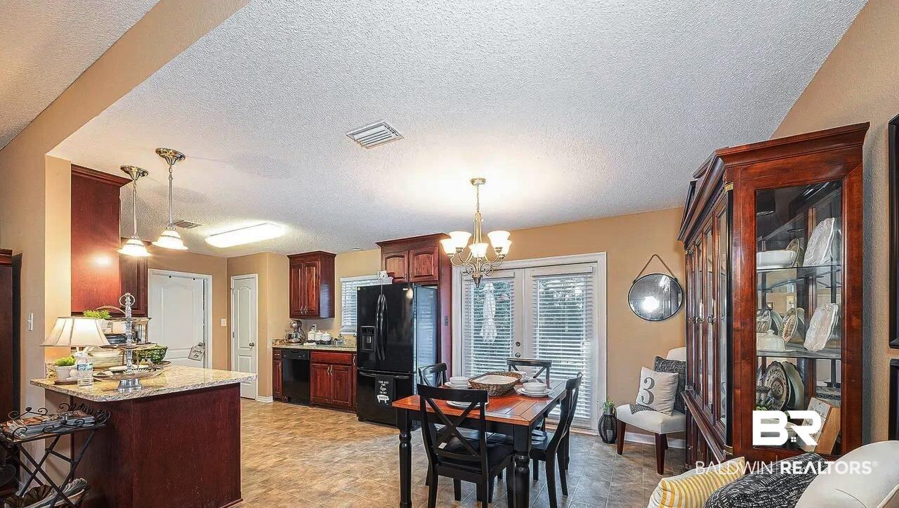 12230 Bromley Road Stapleton, AL 36578 - Photo 9 of 34 Dining area featuring a textured ceiling and a chandelier