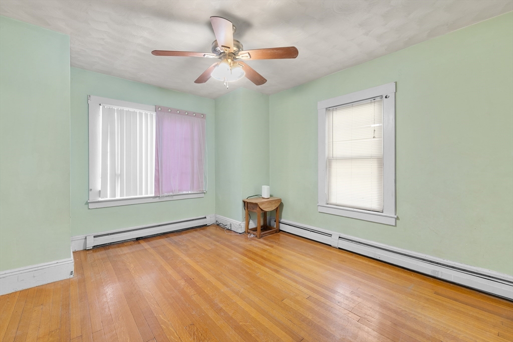 75 Plain Street Lowell, MA 01851 - Photo 8 of 17 a bedroom with a bed and a window