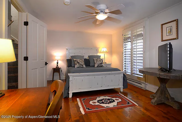 a room with a bed and a flat screen tv