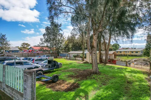 a view of a street with cars parked