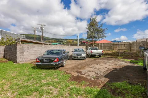 a backyard of a house with table and chairs