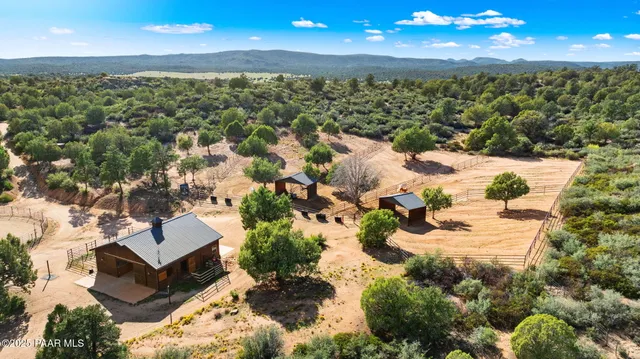 a view of house with yard and outdoor seating