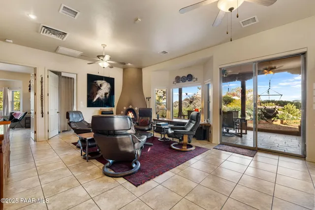 a kitchen with stainless steel appliances a refrigerator a stove a sink cabinets and a dining table