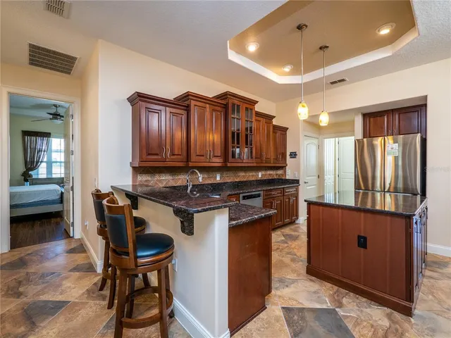 a kitchen with stainless steel appliances granite countertop a stove and a refrigerator