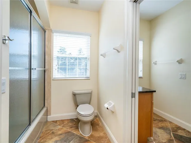 a kitchen with granite countertop cabinets and window