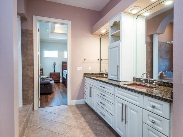 a spacious bathroom with a large tub shower and sink