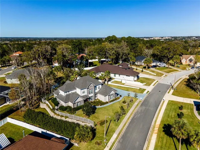 an aerial view of a house with a swimming pool outdoor seating