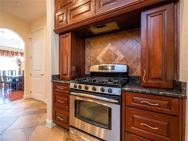 a kitchen with stainless steel appliances granite countertop a stove and a microwave