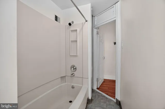 a bathroom with a bathtub and a shower