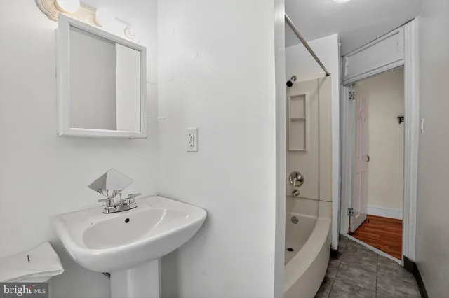 a bathroom with a sink a mirror and a shower