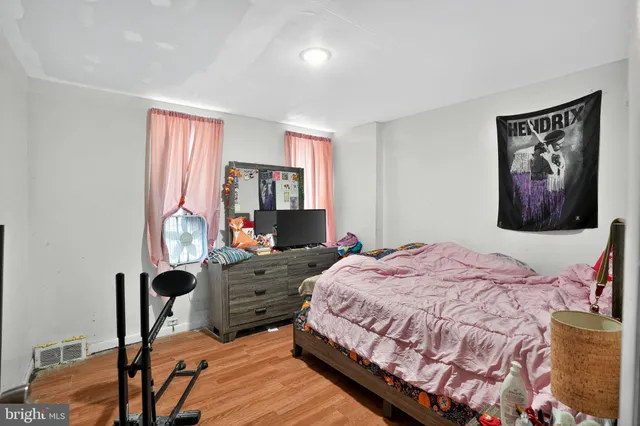 a bedroom with a bed and a painting on the wall