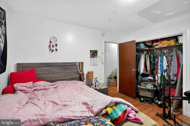 a bedroom with a bed a closet and storage