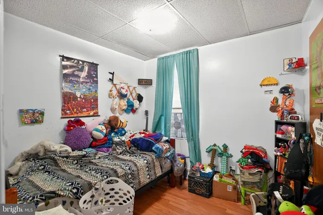 a bedroom with two beds and a large window