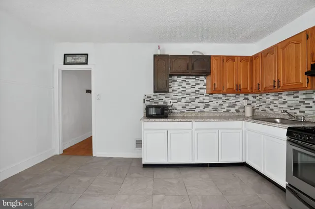 a kitchen with white cabinets