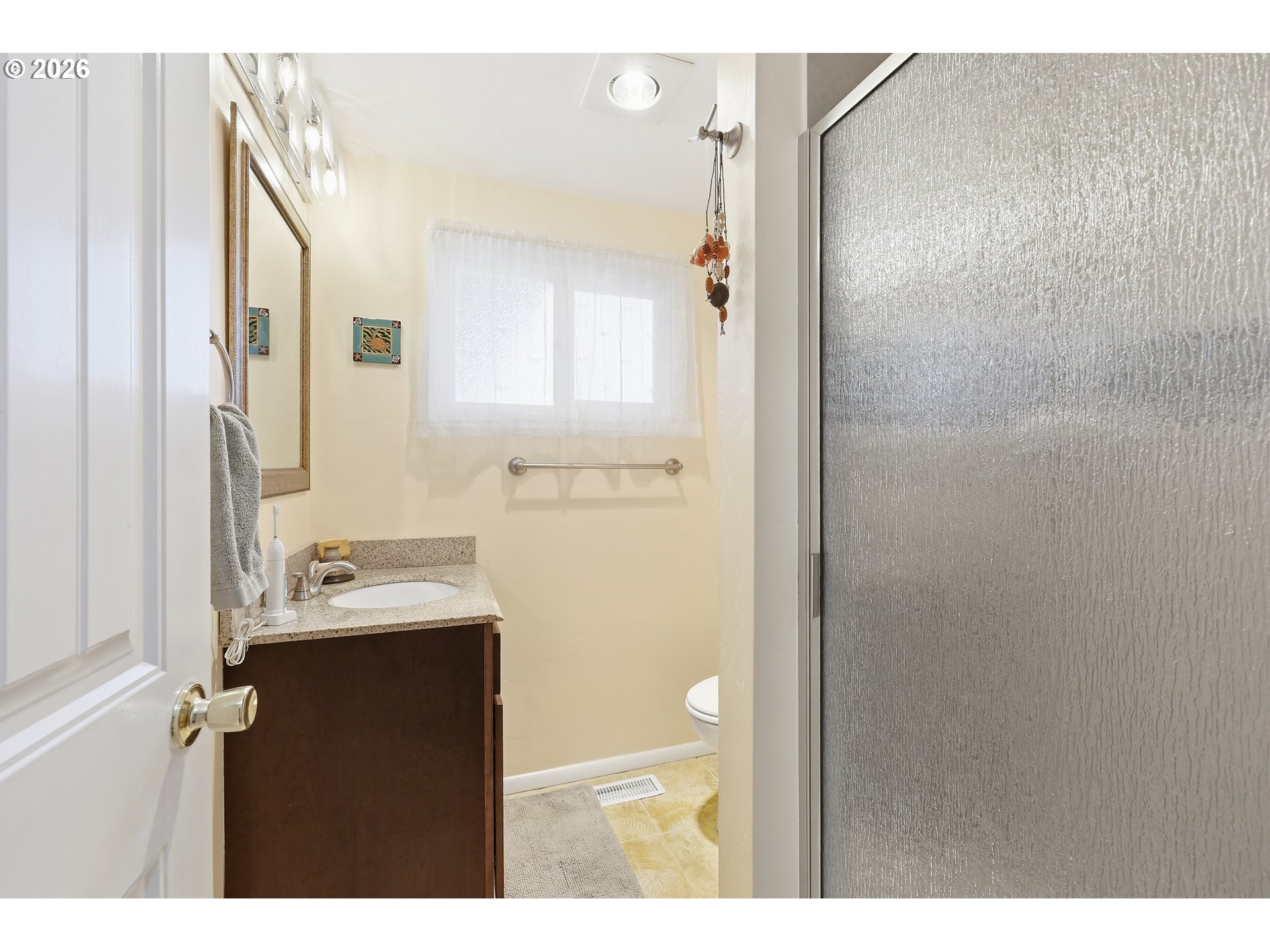 65 Greenvale Drive Springfield, OR 97477 - Photo 21 of 42 a bathroom with a sink mirror and a shower