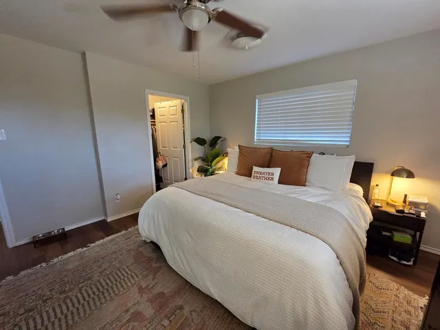 a bedroom with a bed and a desk