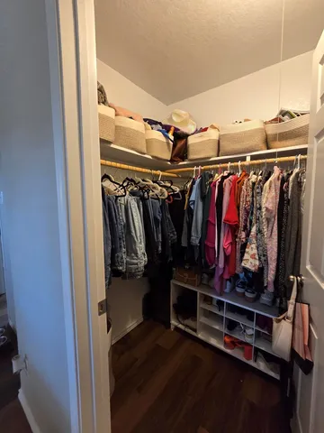 a bathroom with a granite countertop sink a toilet a mirror and vanity