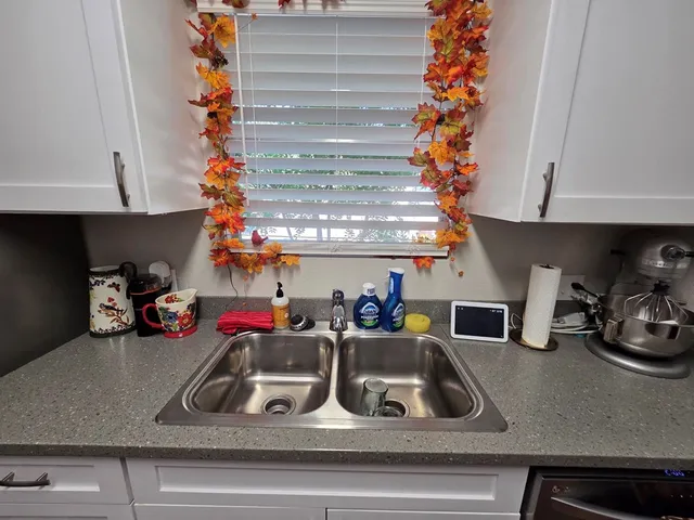 a kitchen that has a sink and a stove top oven