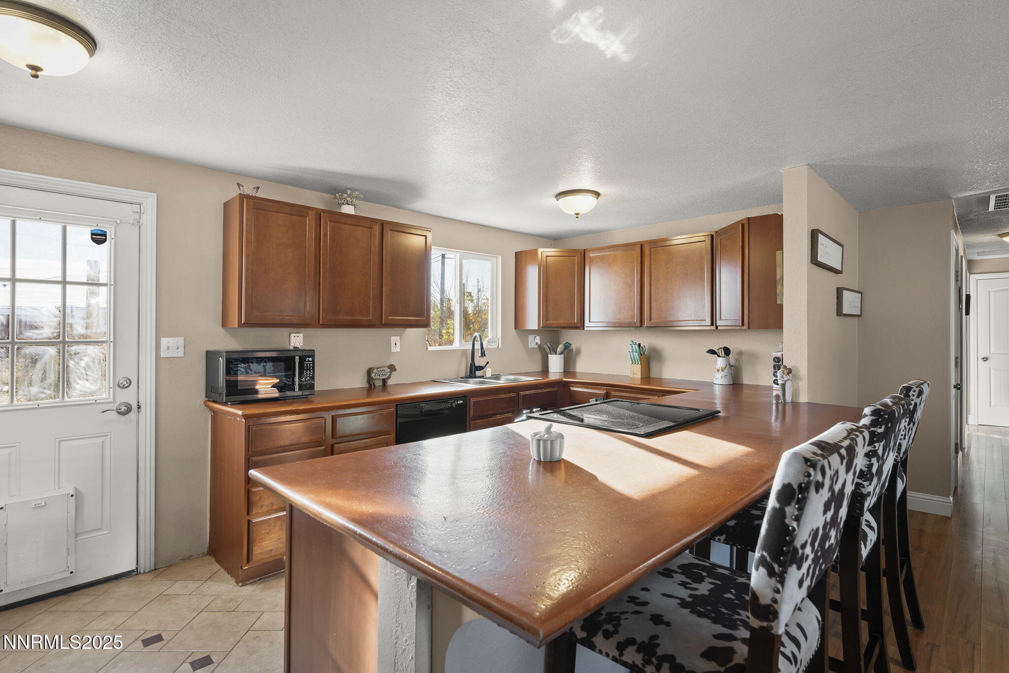 11600 Tupelo Street Reno, NV 89506 - Photo 5 of 23 a kitchen with stainless steel appliances granite countertop a stove a sink a microwave and a refrigerator